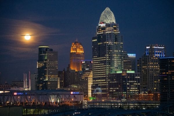  A photograph of the Cincinnati skyline taken at night with a full moon by Ryan Sciamanna.